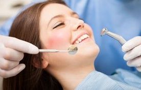 Dentist doing a dental treatment on a female patient